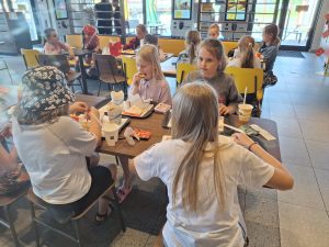 Grupa dzieci podczas posiłku w McDonald's