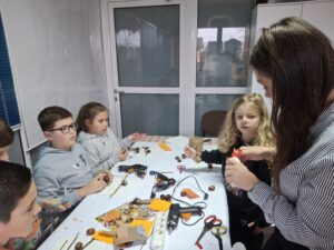 20251113_150539 Dzieci na warsztatach, robiące ptaszki z kasztanów