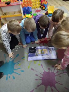 Dzieci oglądające książkę.