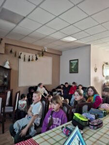 Dzieci oglądające prezentację na ekranie.