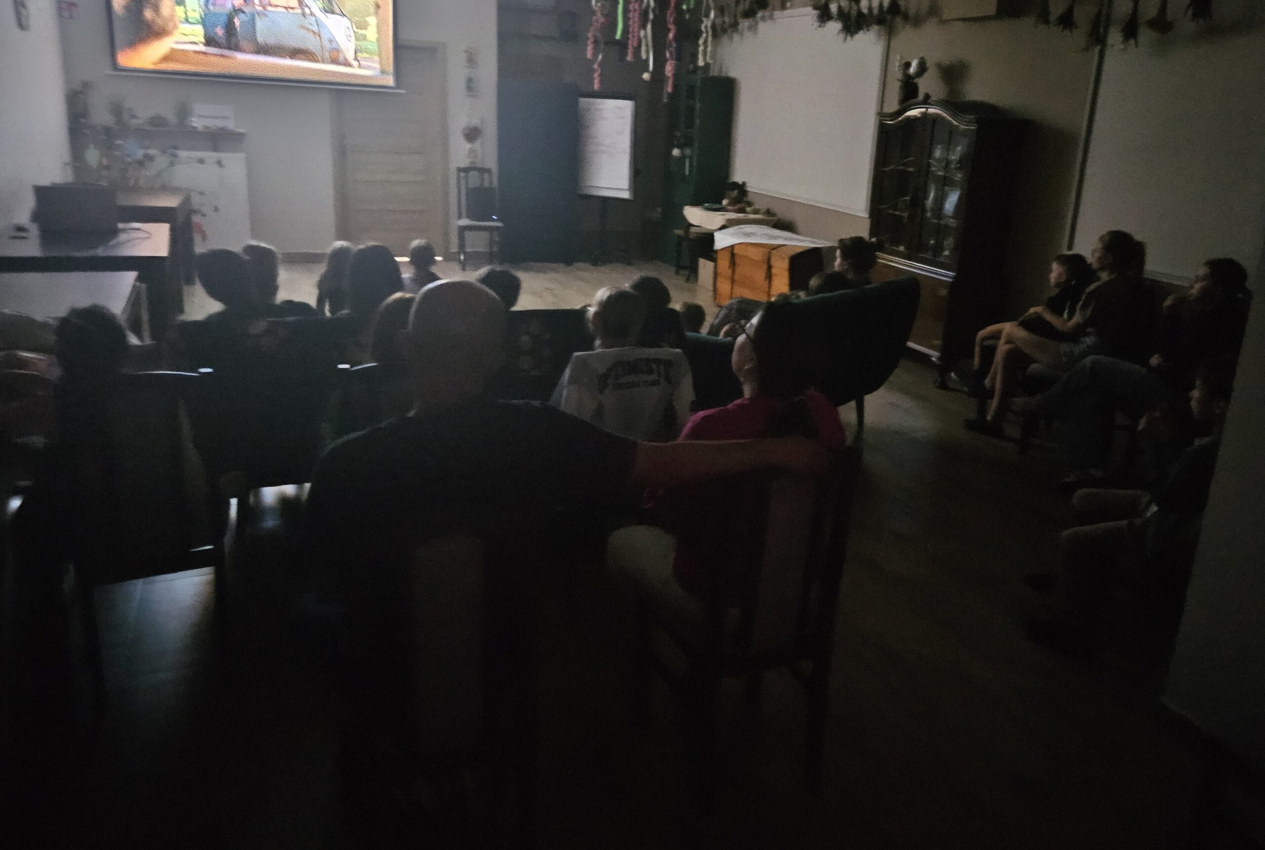 Ludzie oglądający projekcję na dużym ekranie.